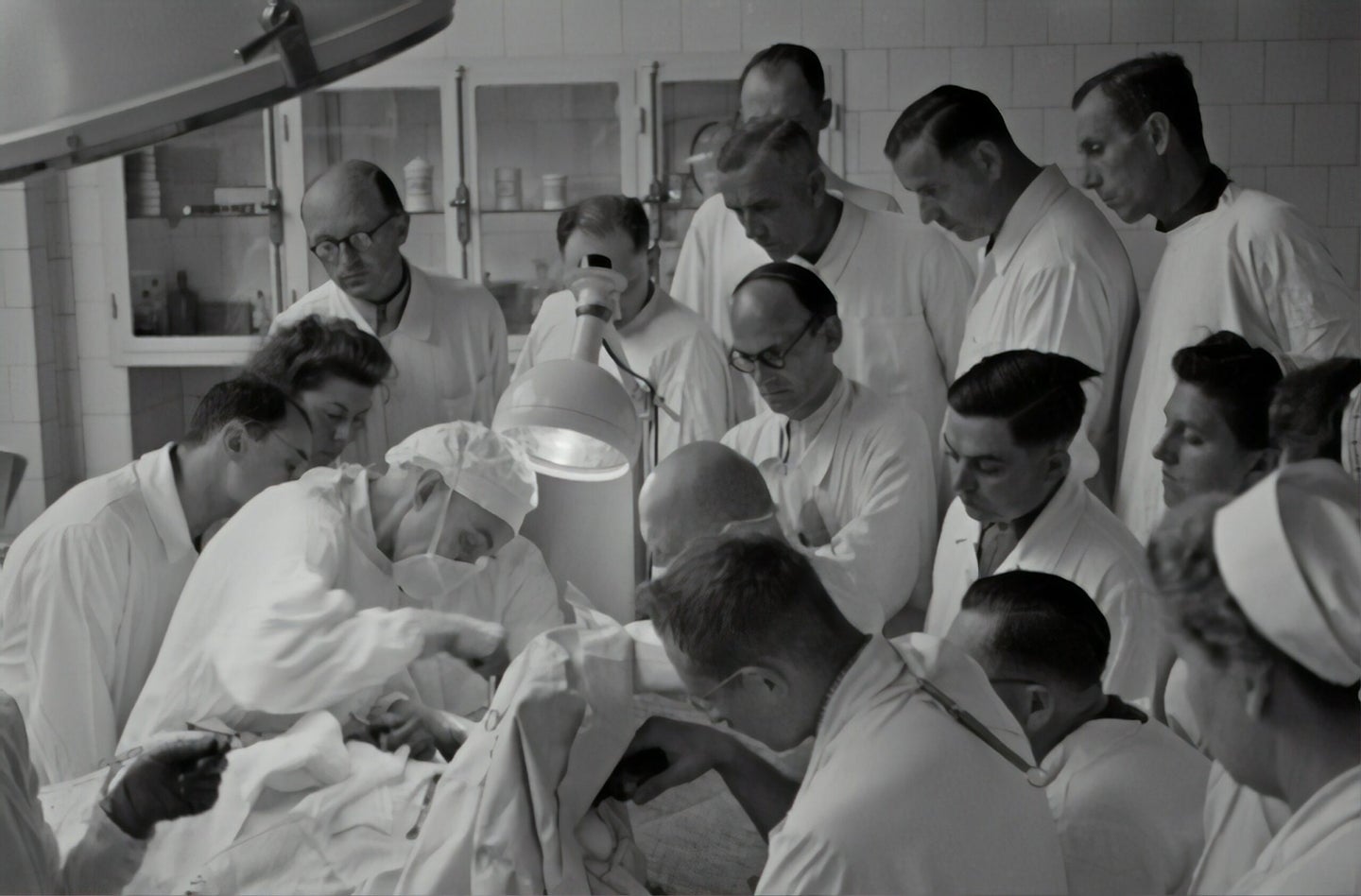 doctors gathered around patient in 1940s