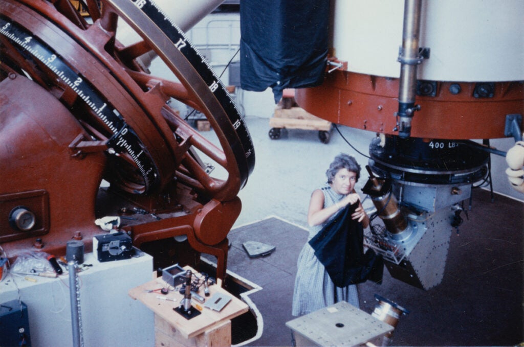 Vera Rubin adjusts a telescope at the Lowell Observatory in Flagstaff, Arizona.