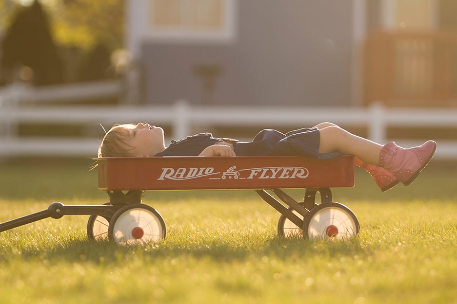 kid laying down in a wagon