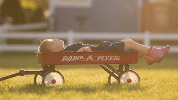 kid laying down in a wagon