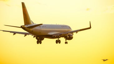 A Delta passenger plane taking off into the sun