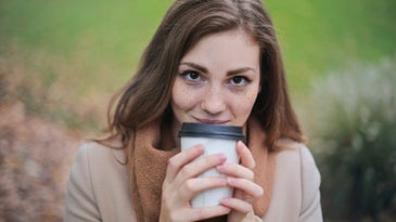 woman drinking coffee and smiling