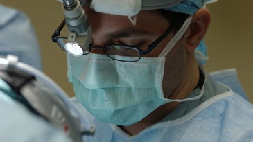 a surgeon wearing a surgical mask during surgery