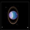 The sideways Uranus system with four rings and ten of its moons, as seen by the Hubble Space Telescope.