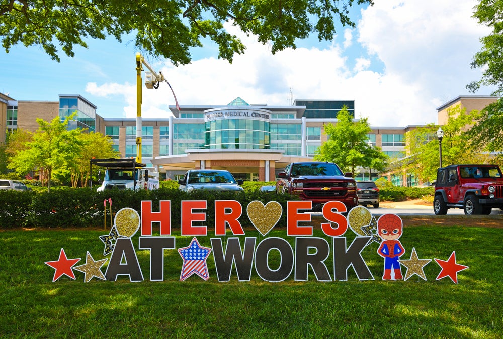 A "heroes at work" sign in front of the Tanner Medical Center in Carrollton, Georgia, honors the medical staff treating COVID-19 patients.