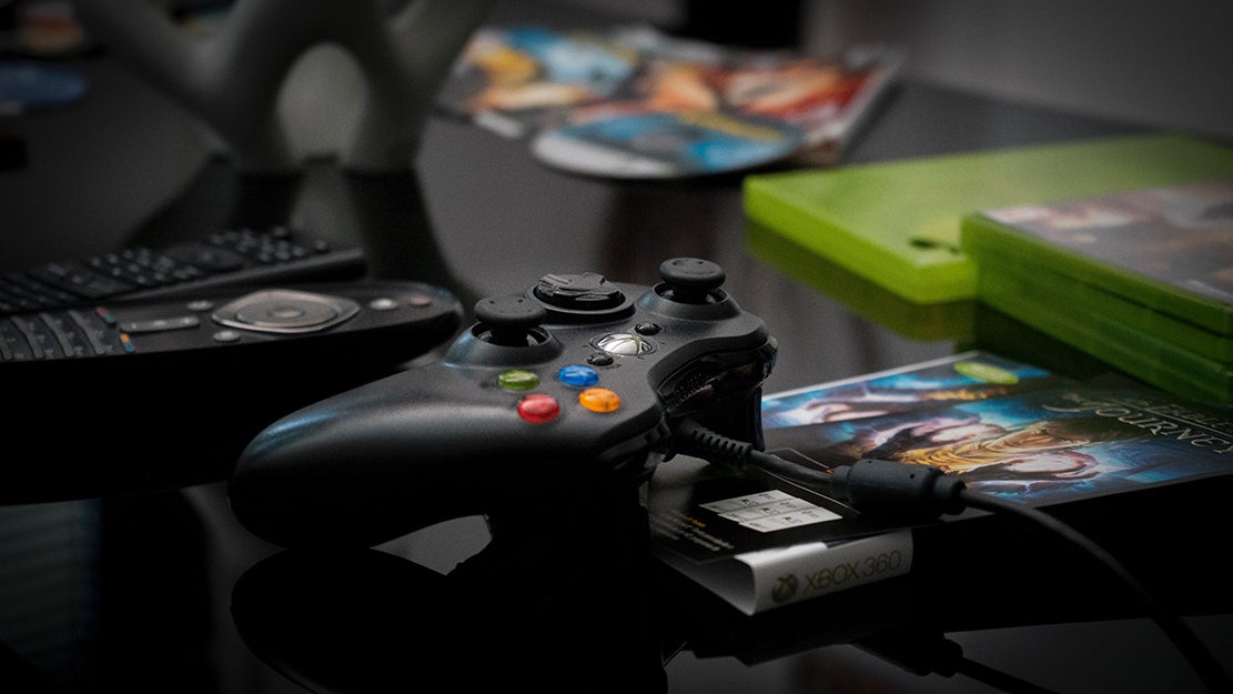 xbox controller and games on a table