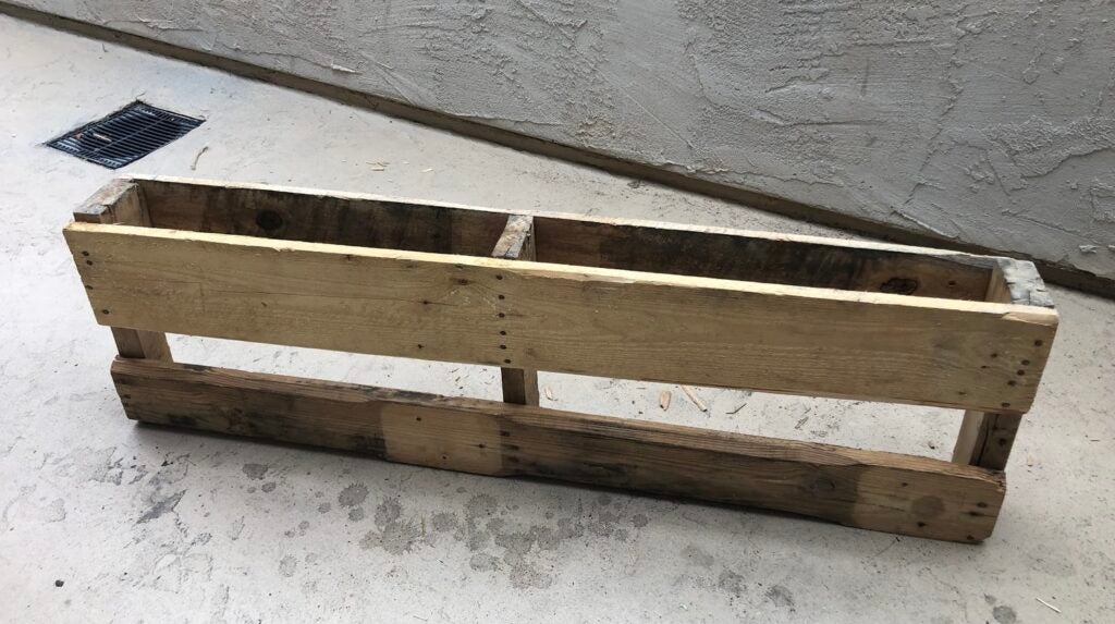a section of wood pallet that will eventually become a wall-mounted wine rack