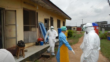 World health organization workers wearing PPE during the Ebola epidemic.