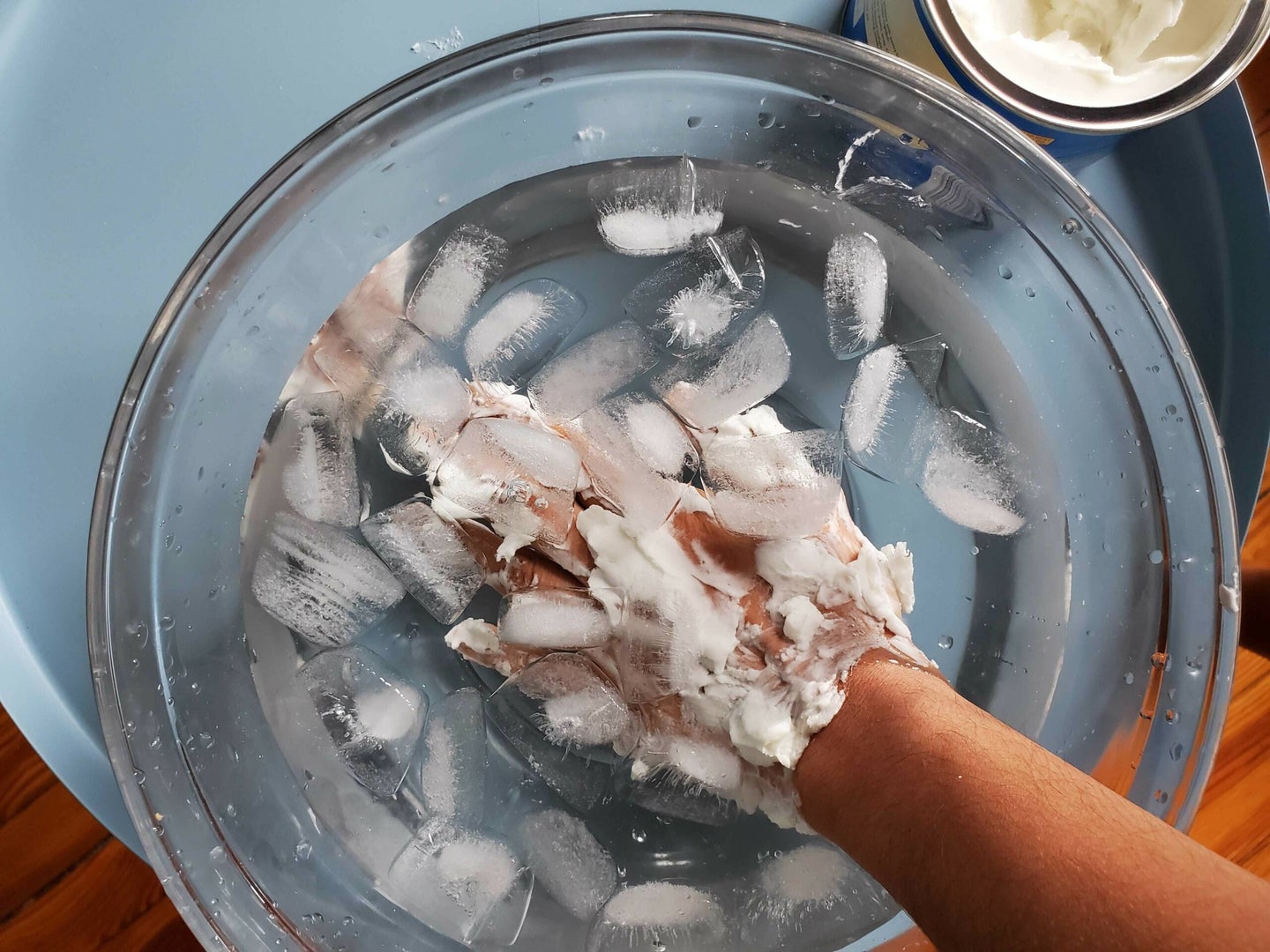 Dipping shortening-covered hands in ice water
