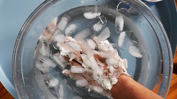 Dipping shortening-covered hands in ice water
