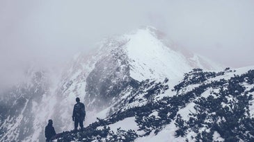 Hiker climbing a snowy mountain.