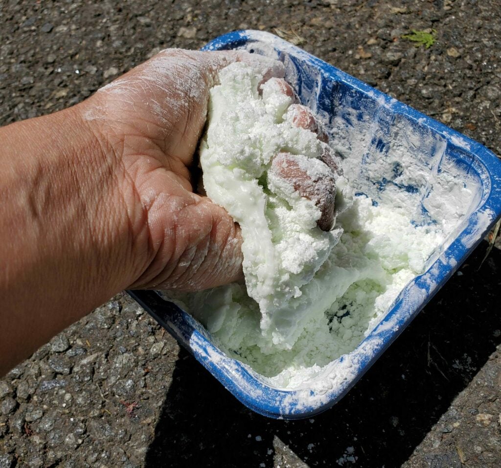 Mixing starch and soap with hands
