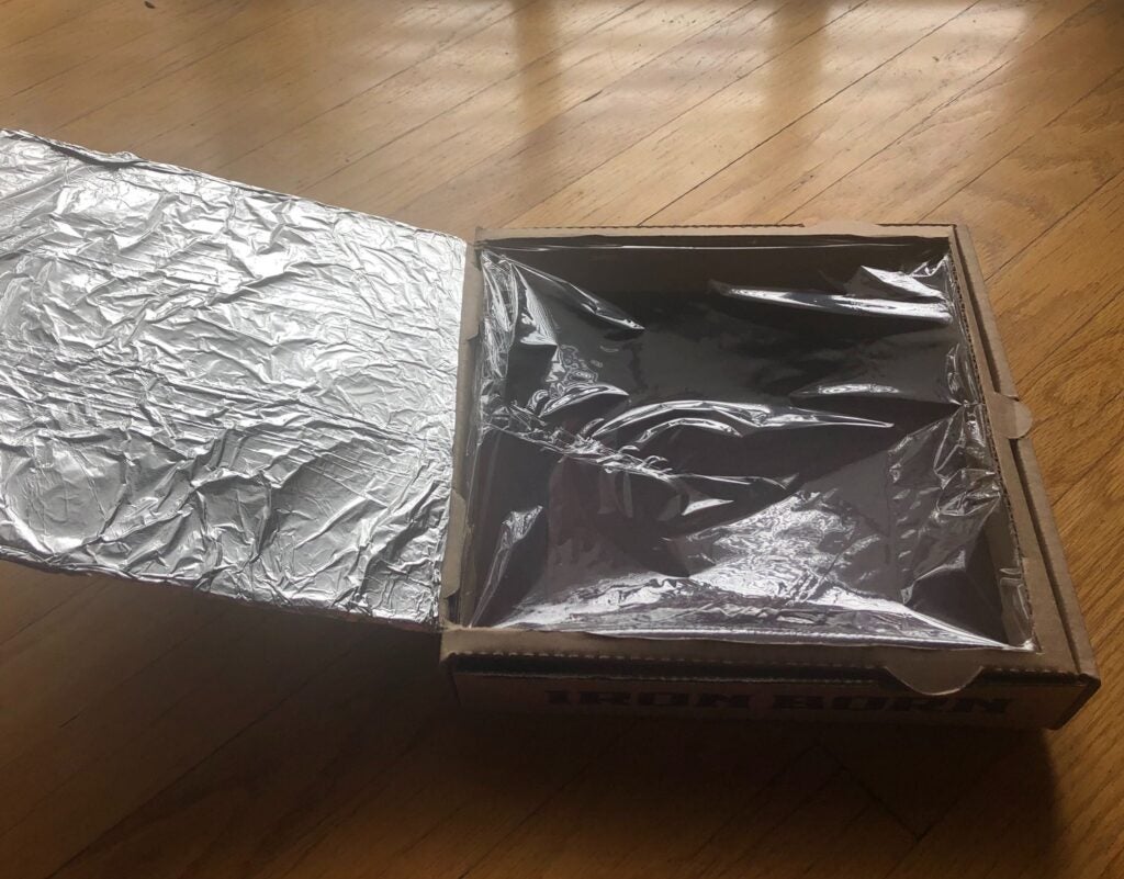 a DIY solar oven with aluminum foil and plastic wrap