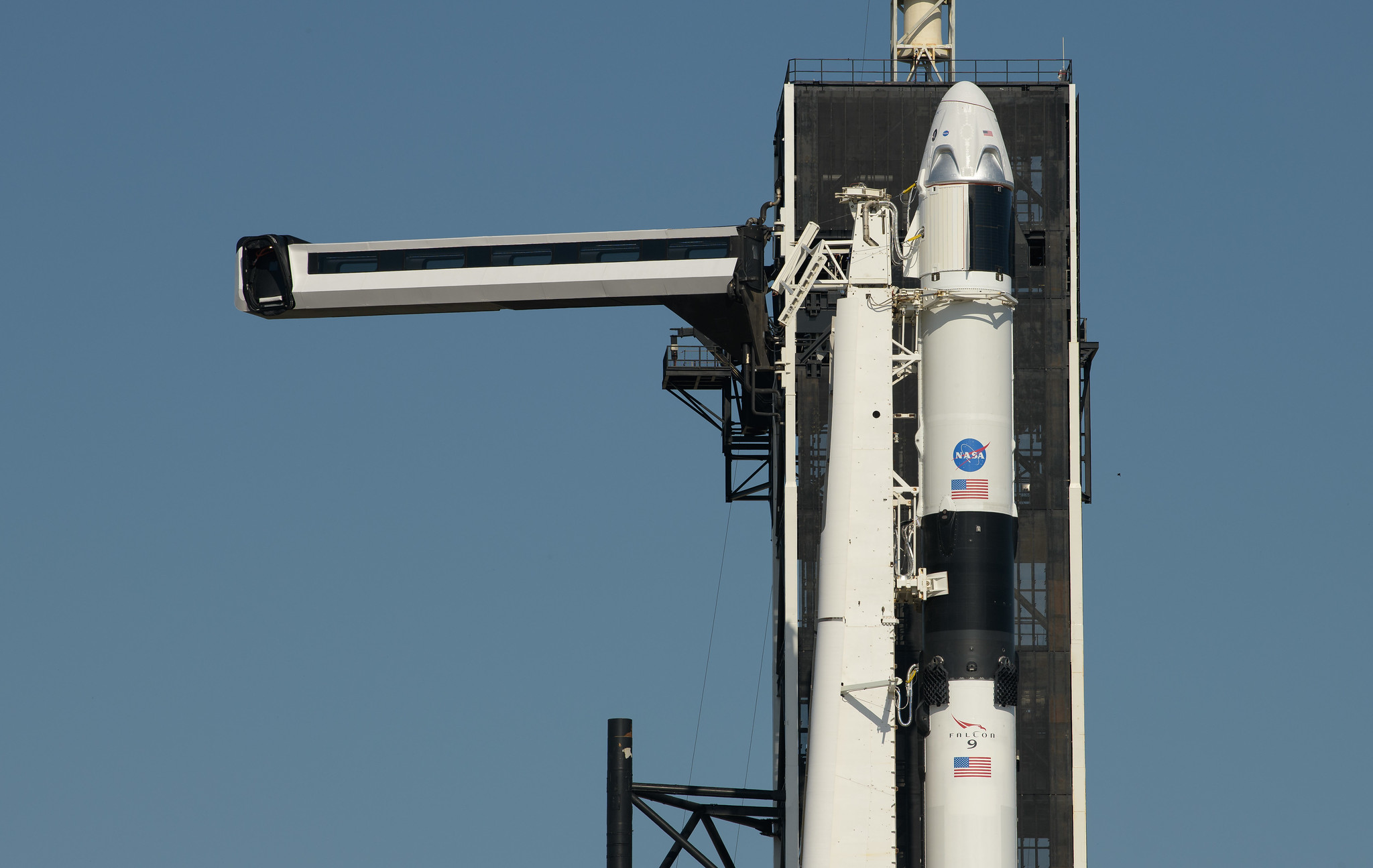 SpaceX’s Crew Dragon capsule sits atop its Falcon rocket, ready to launch.