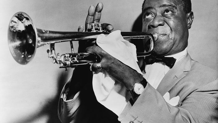 Louis Armstrong playing a trumpet