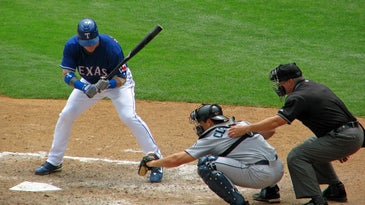 An MLB umpire calls a strike or a ball during a 2019 game.