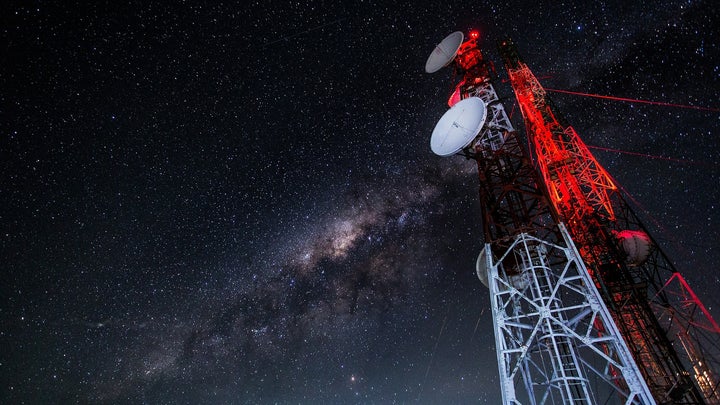 A radio tower set against a night sky.