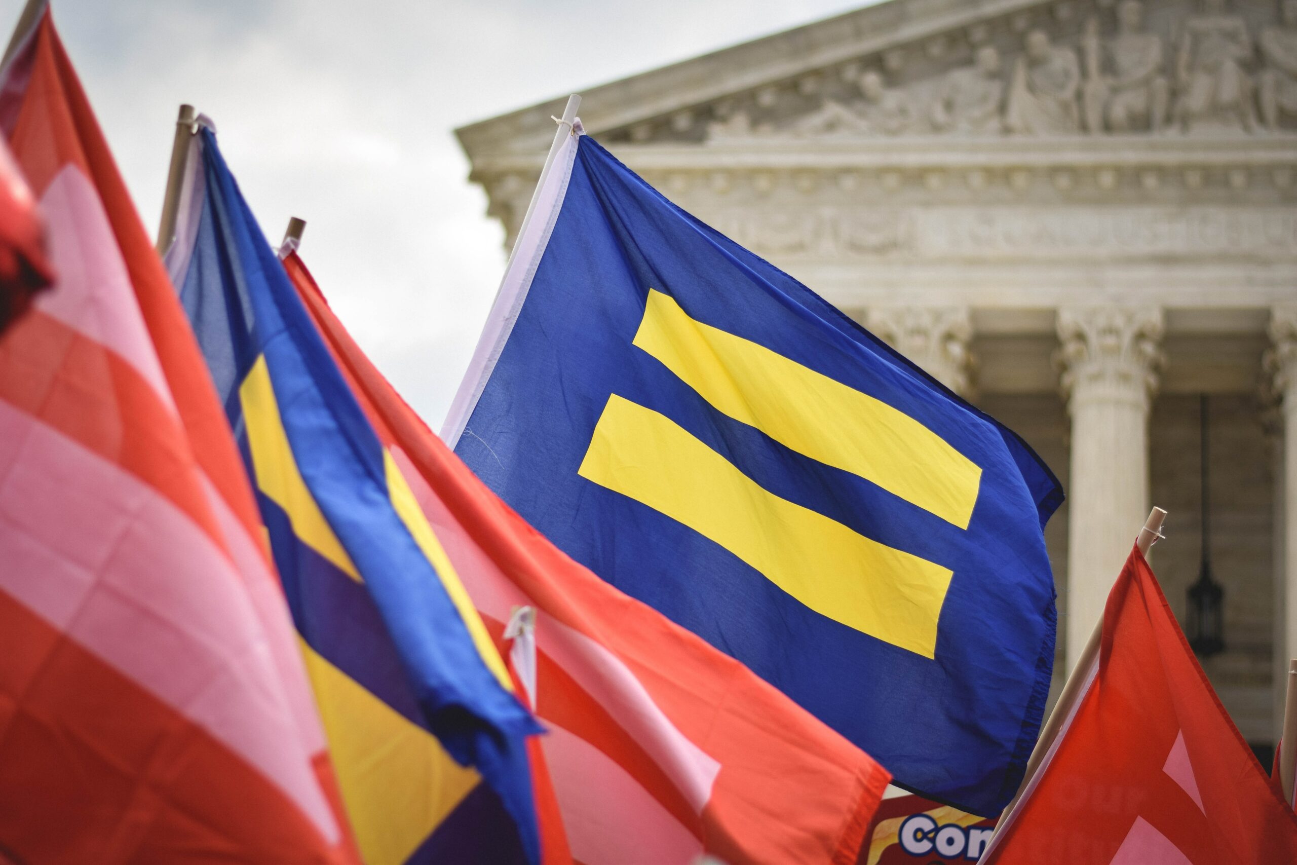 LGBTQIA+ advocates rally in front of the Supreme Court of the United States.