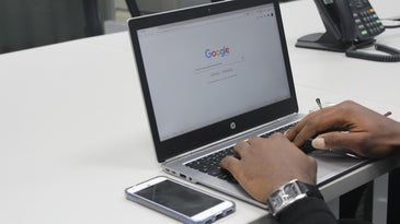 a person using the Google search engine on a laptop