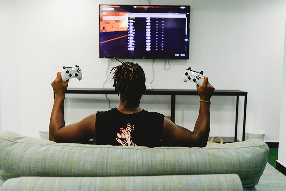 person playing video games on a tv