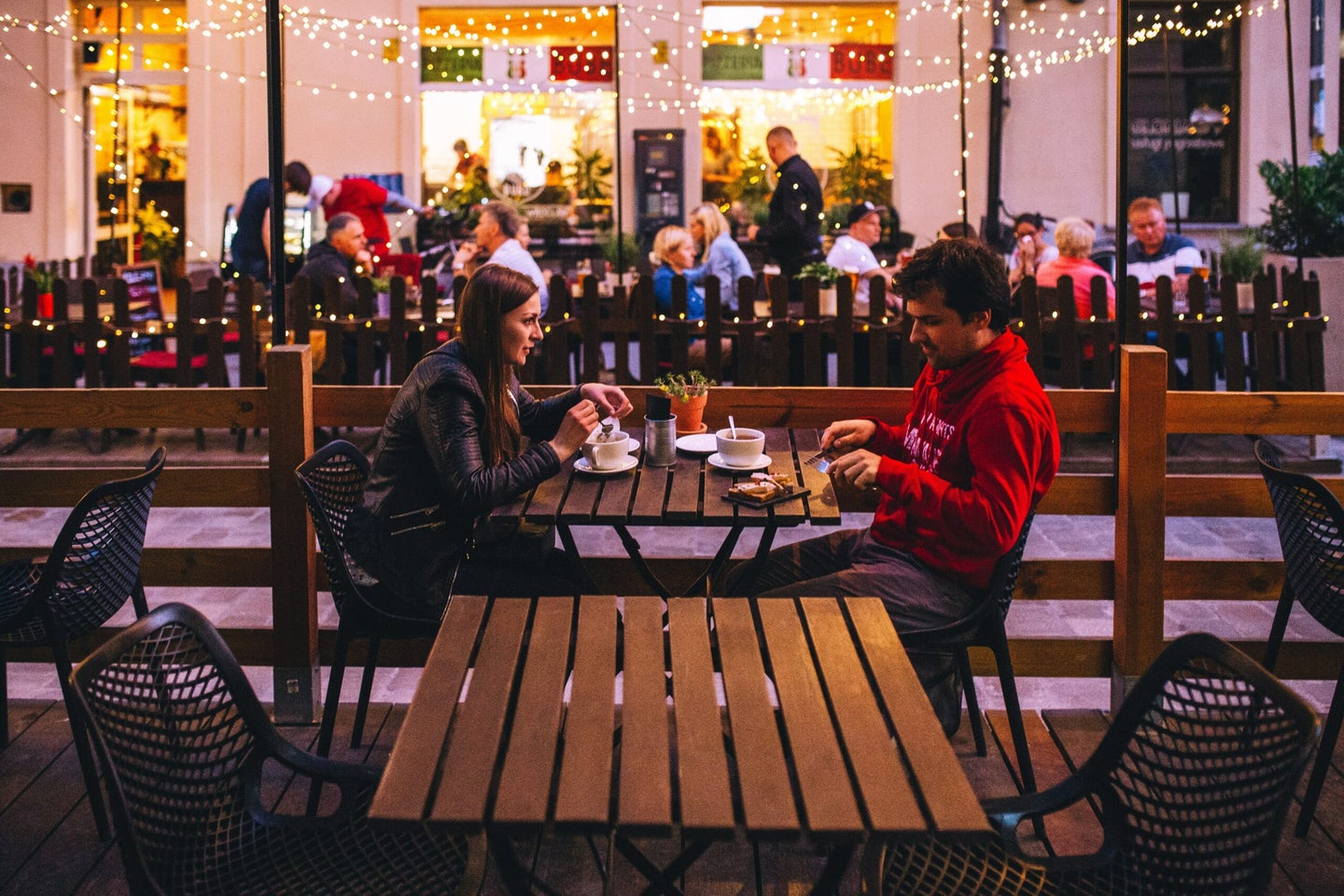 two people eating outside at a restaurant