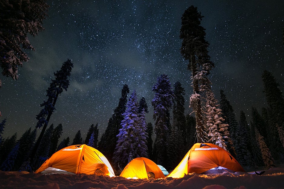 three tents at night with lights