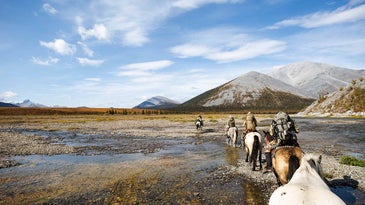 American hunters on horseback through the Yukon