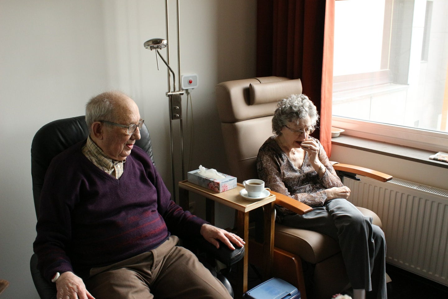 two older people sitting in chairs