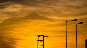 power line silhouette against reddish sunset