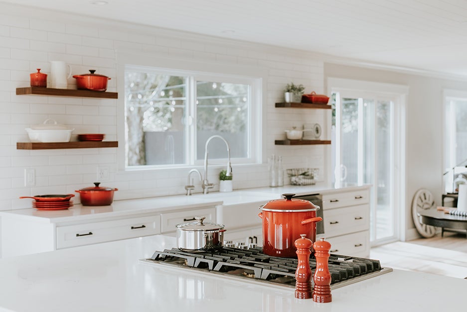 kitchen with red pots and pans