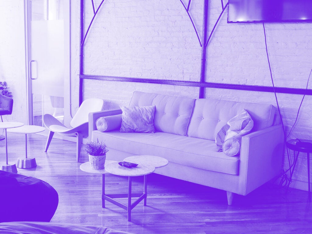 purple monochrome photo of couch in office space