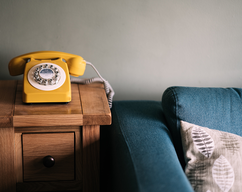 couch and phone on a side table