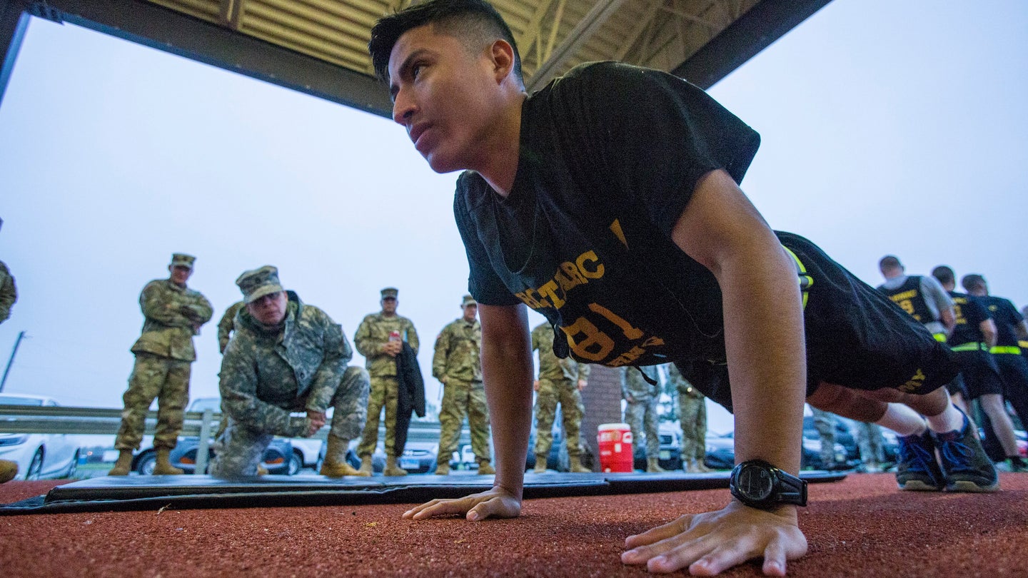 A US Army National Guard soldier does a push-up in front of a drill sergeant