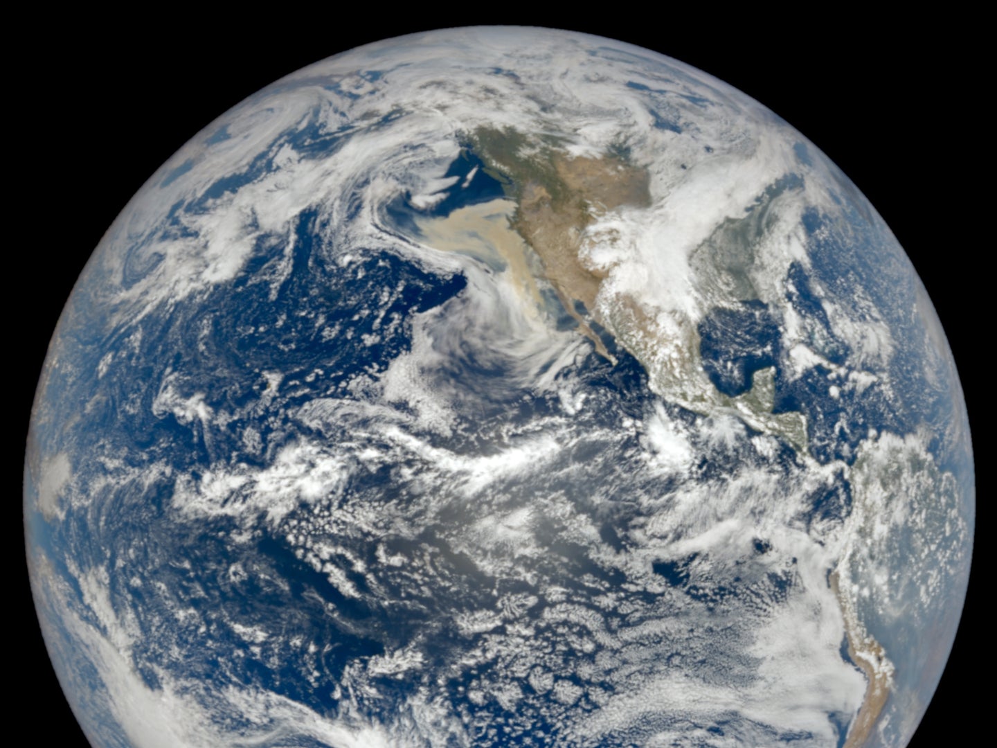 The photo was taken by NASA’s camera EPIC, which takes pictures of the planet every two hour  from NOAA’s satellite DSCOVR. You can spot the plume of wildfire smoke off the west coast of the United States.