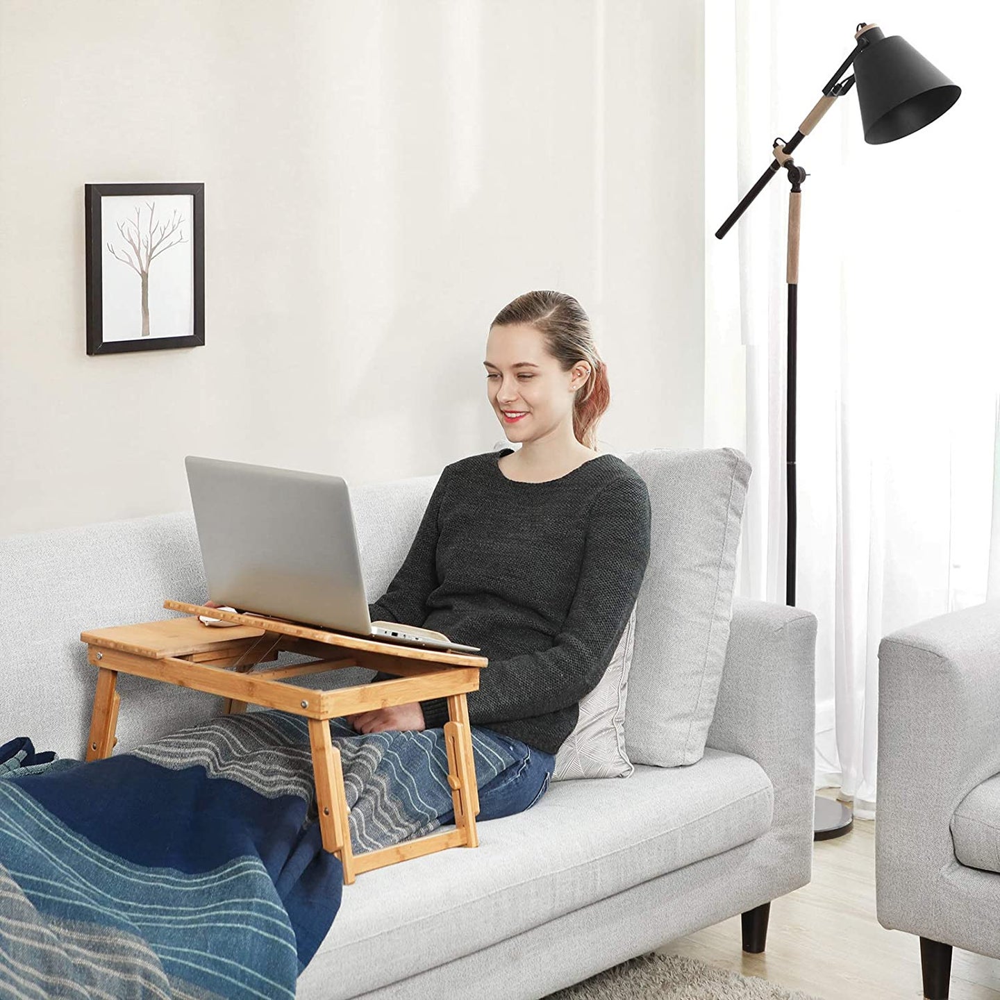 person using a lap desk on a couch