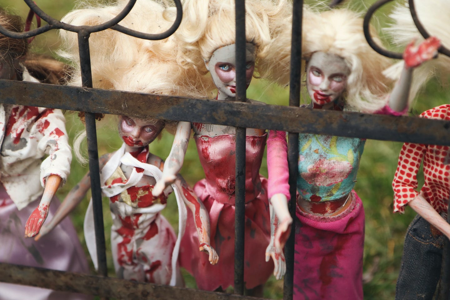 A row of Barbie dolls with fake blood