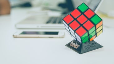 A Rubik's Cube displayed on a stand