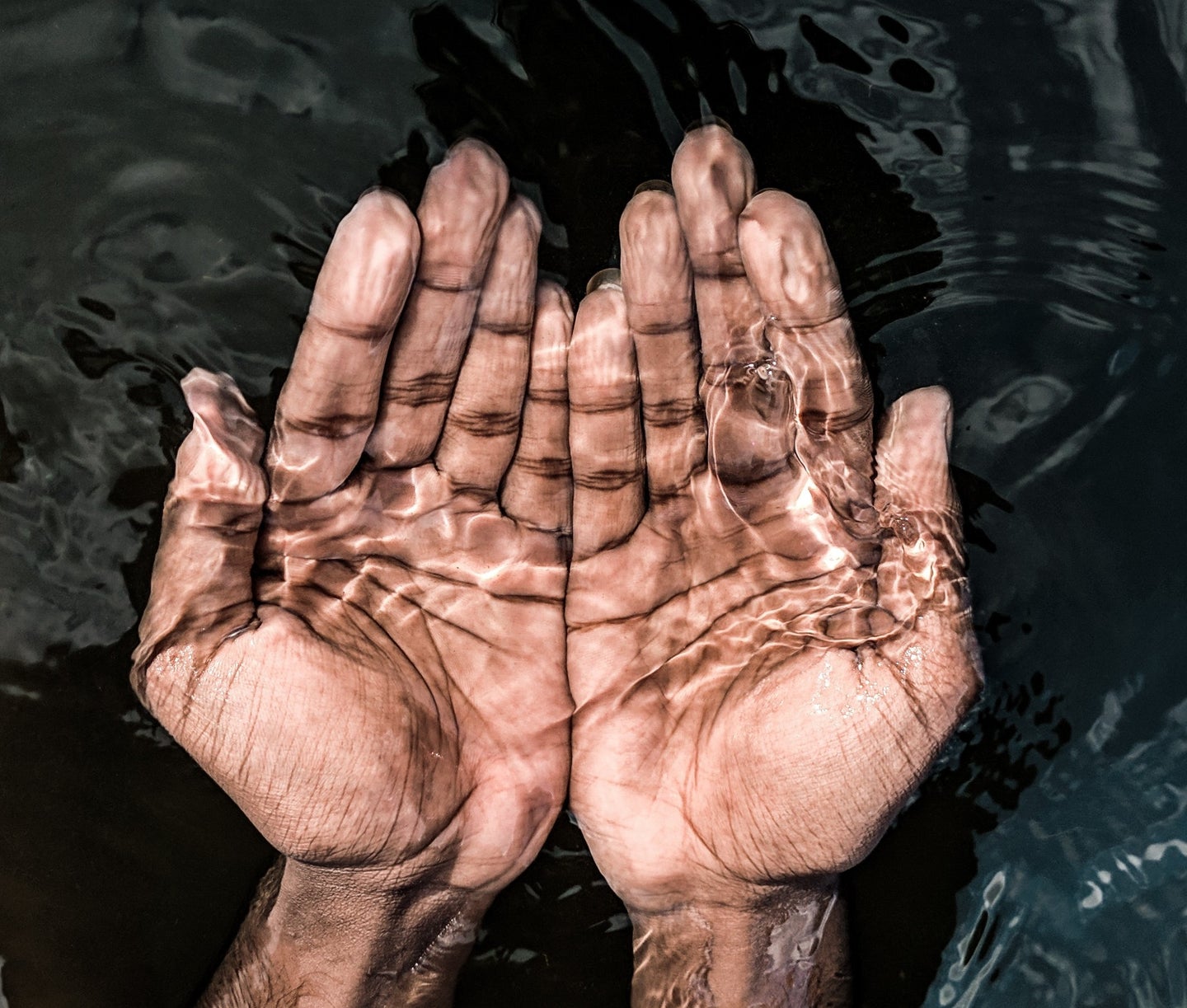 a person with their hands in the water