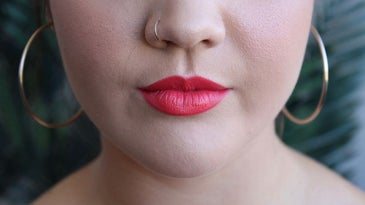 Woman wearing a colored lip balm.