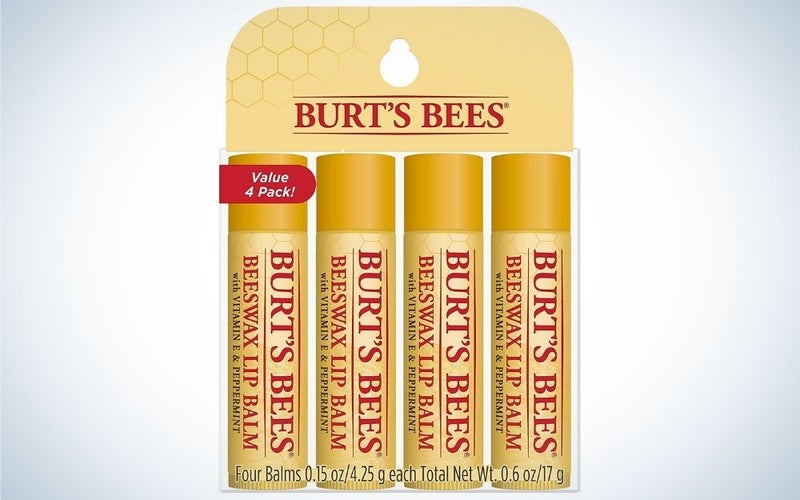 Fours pieces of golden lip balm in line with each other with the tittle over them Burt's Bees.