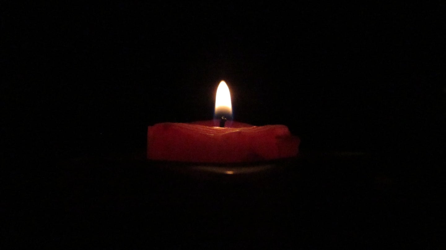 a candle in the darkness