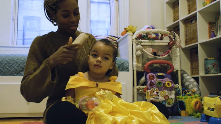 Bianca Jones Marlin brushing her daughter's hair in a playroom