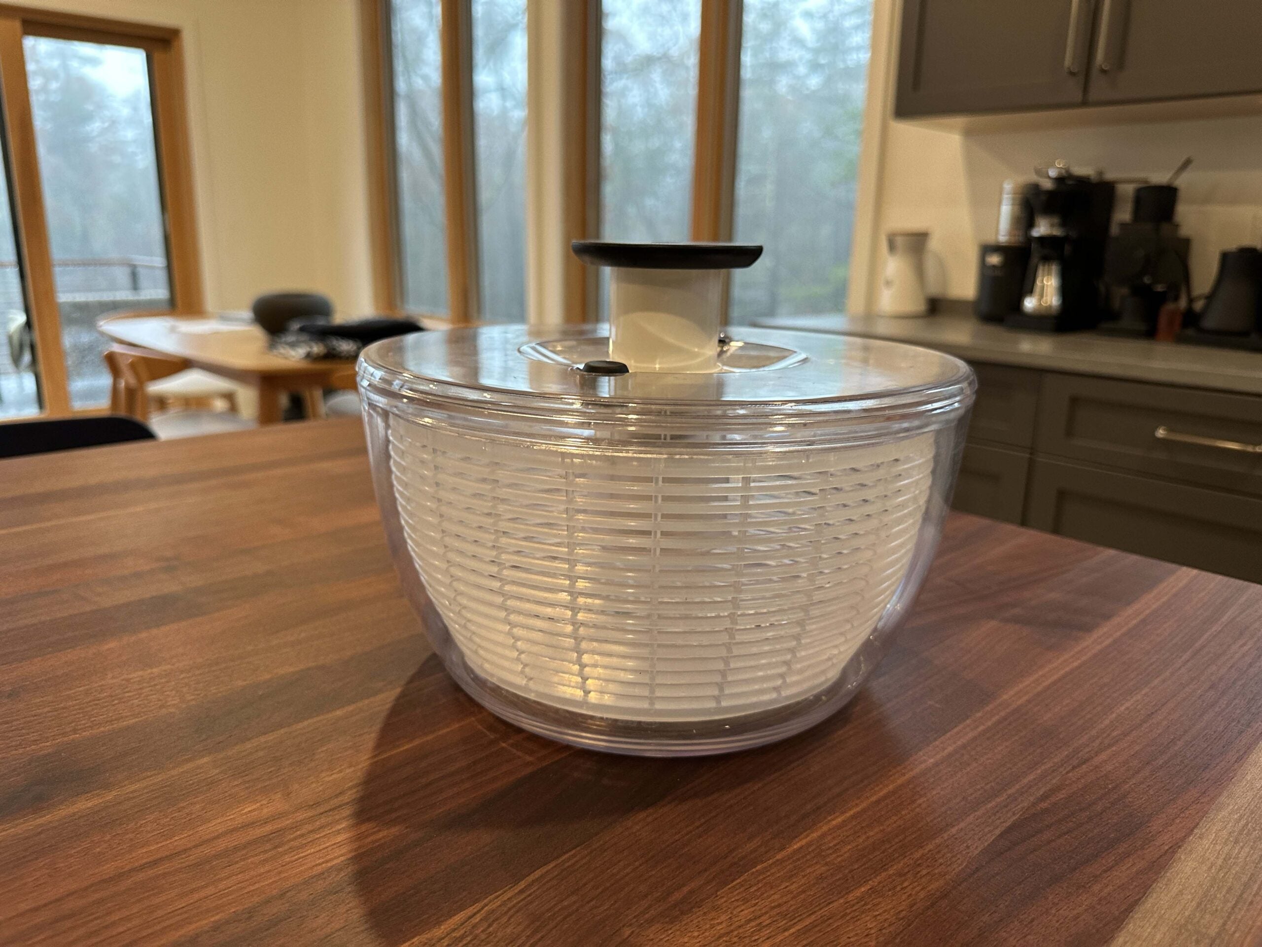 OXO Good Grips Salad Spinner sitting on a wood countertop