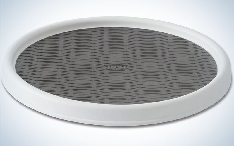 A turntable cabinet with two colors, gray and white on the side, in an oval and large shape.