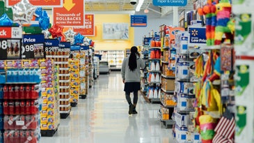a person walking down an aisle in a store