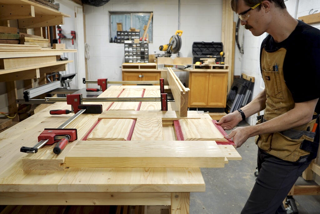 a person assembling a traditional frame-and-panel door