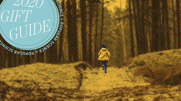 Person in a yellow jacket running the woods