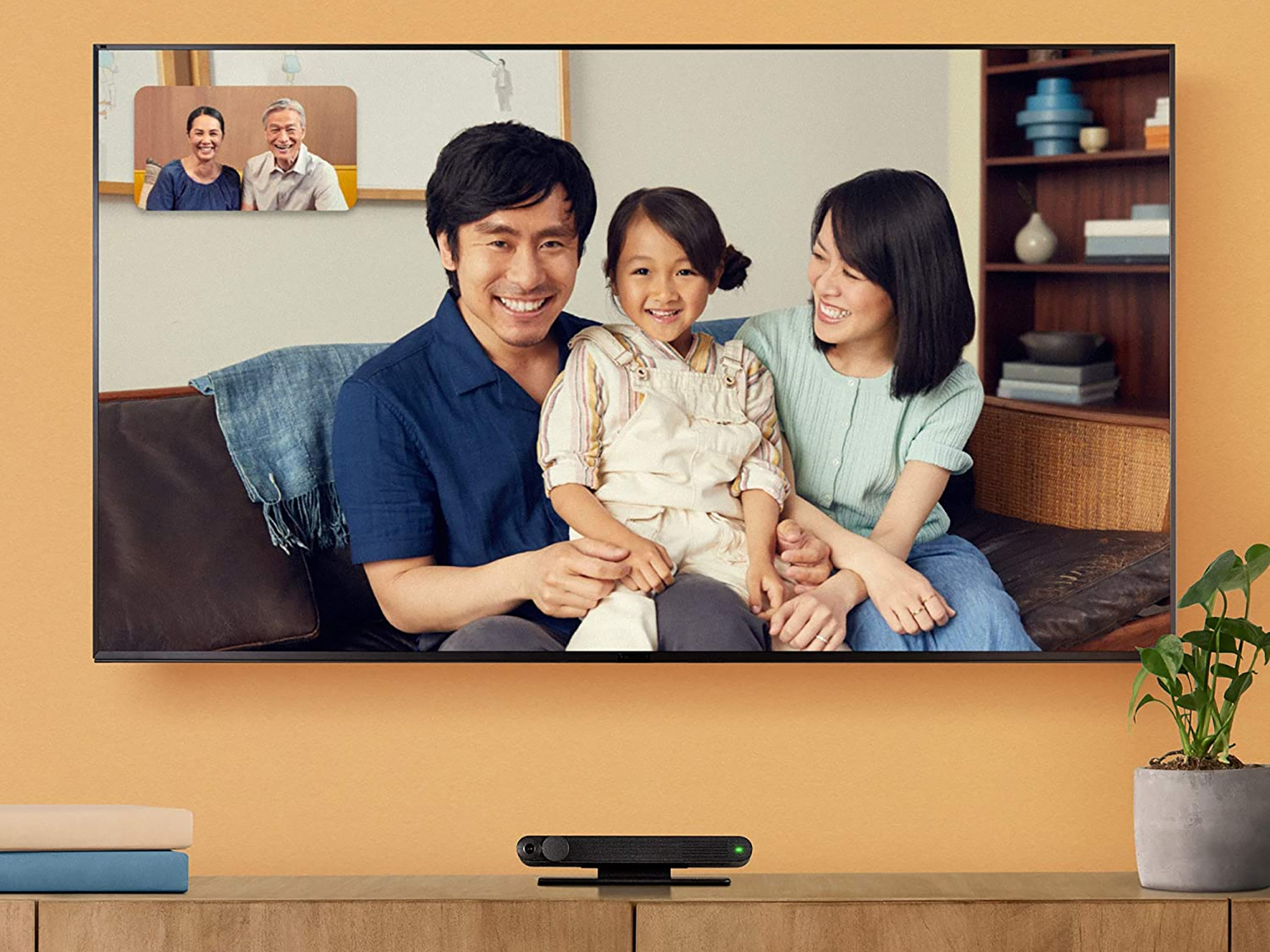 a TV with a family video chatting on it over a video call