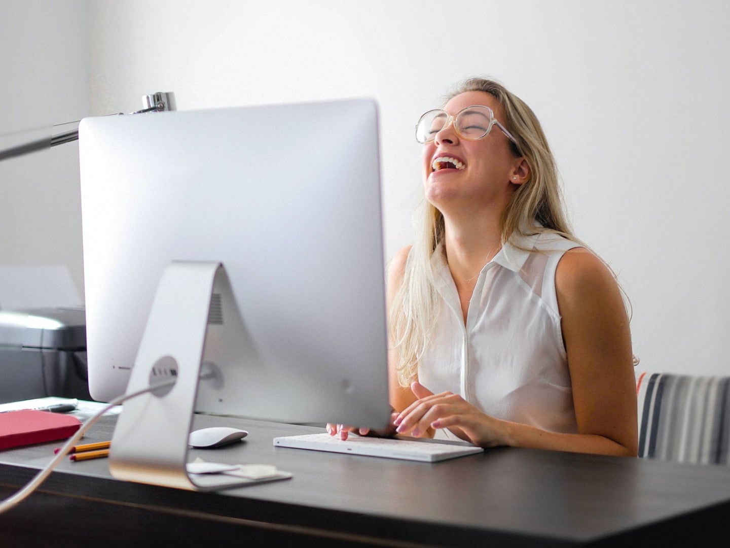Person laughing at computer