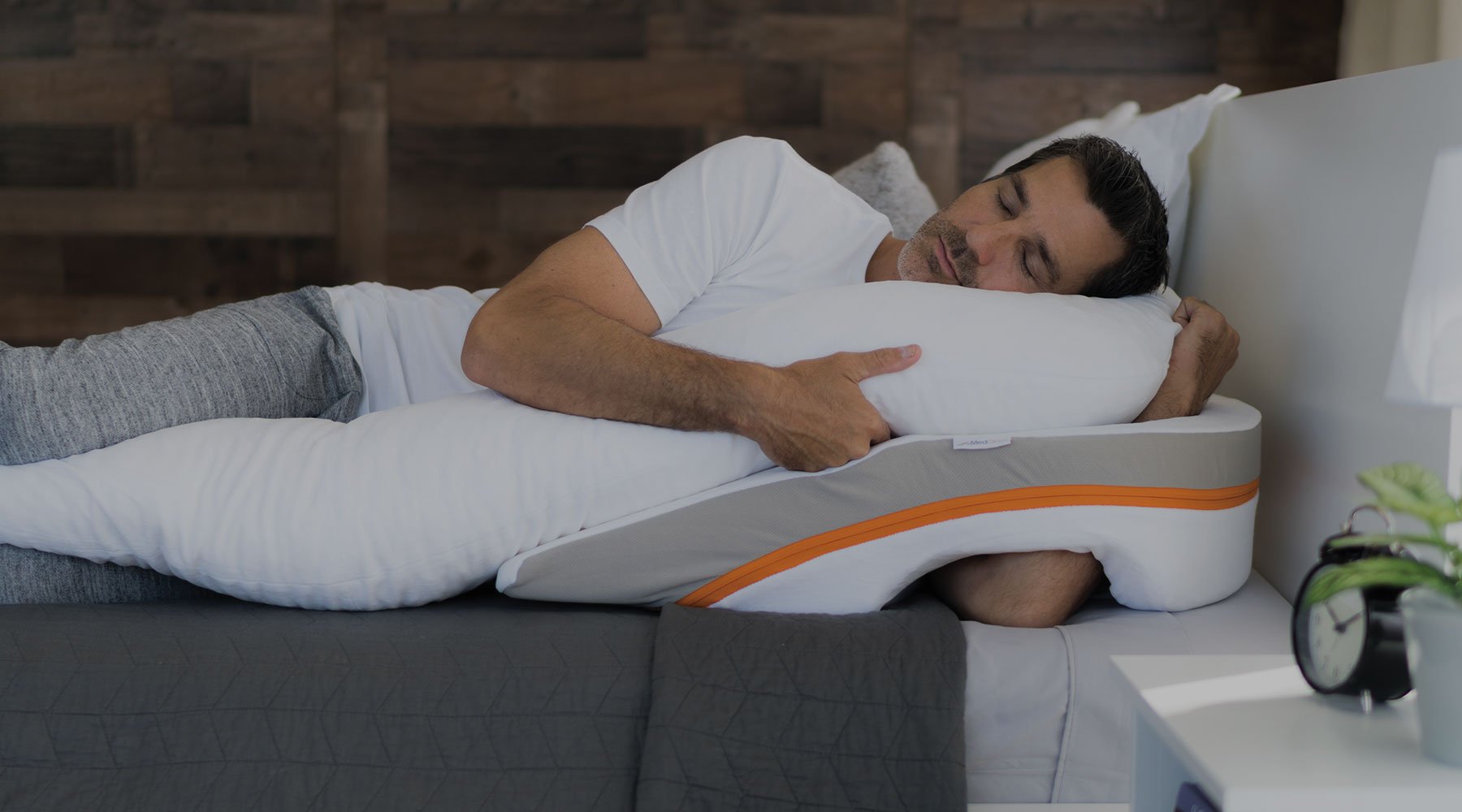 a man sleeps on a wedge pillow